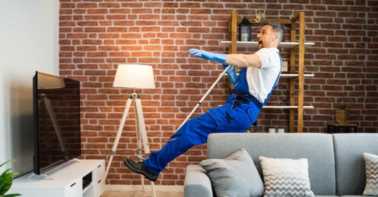man cleaning falling in apartment